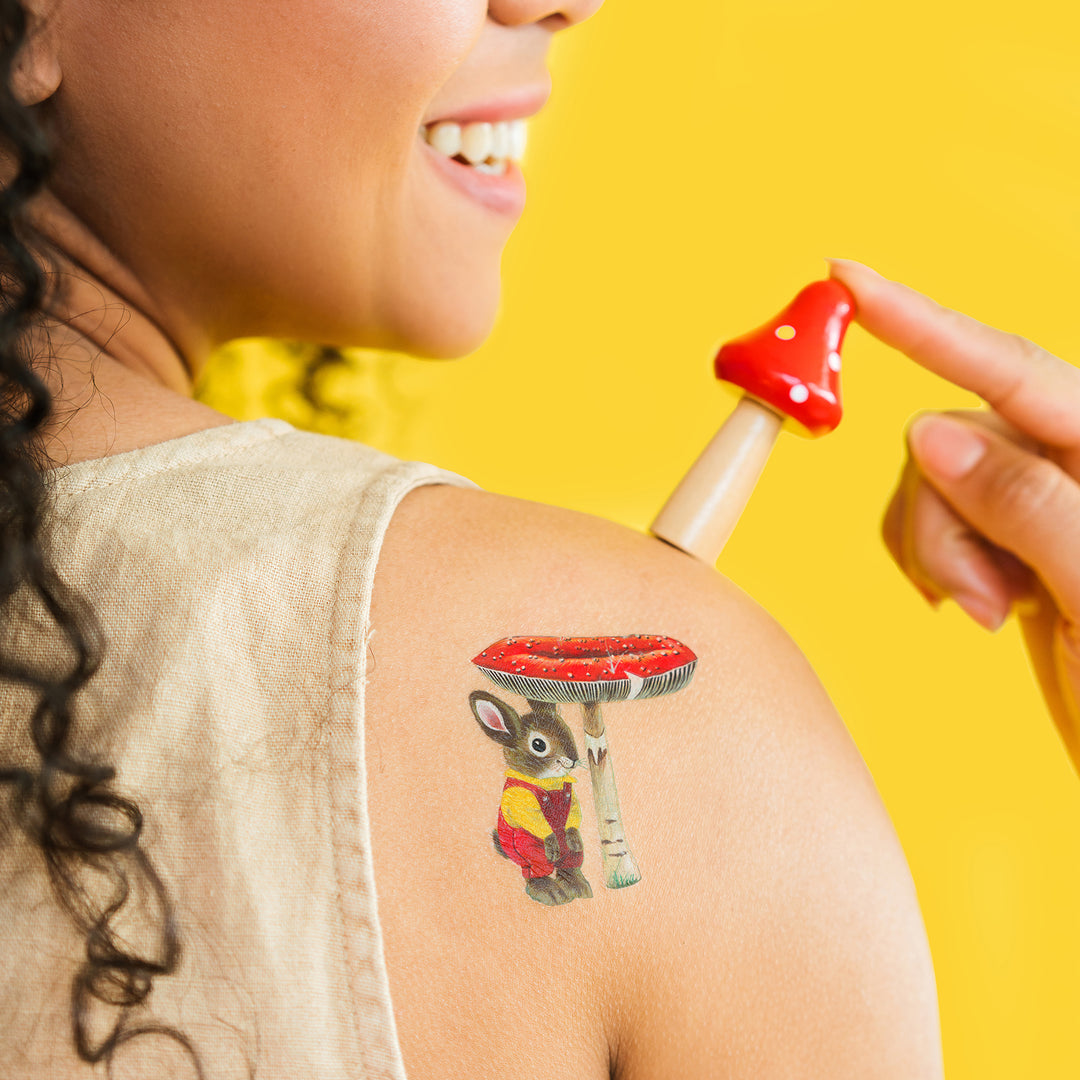 Bunny Under A Toadstool Tattly Temporary Tattoo by Richard Scarry On A Person's Shoulder