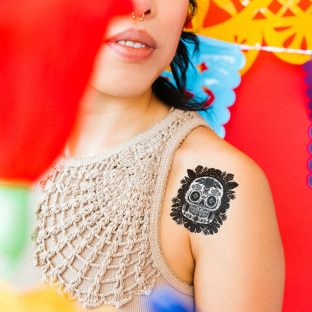 Black And White Sugarskull Tattly Temporary Tattoos On A Person's Shoulder