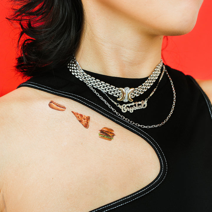 Slice Of Pizza, Hot Dog In A Bun, and A Hamburger On A Bun Tattly Temporary Tattoos On A Person's Shoulder